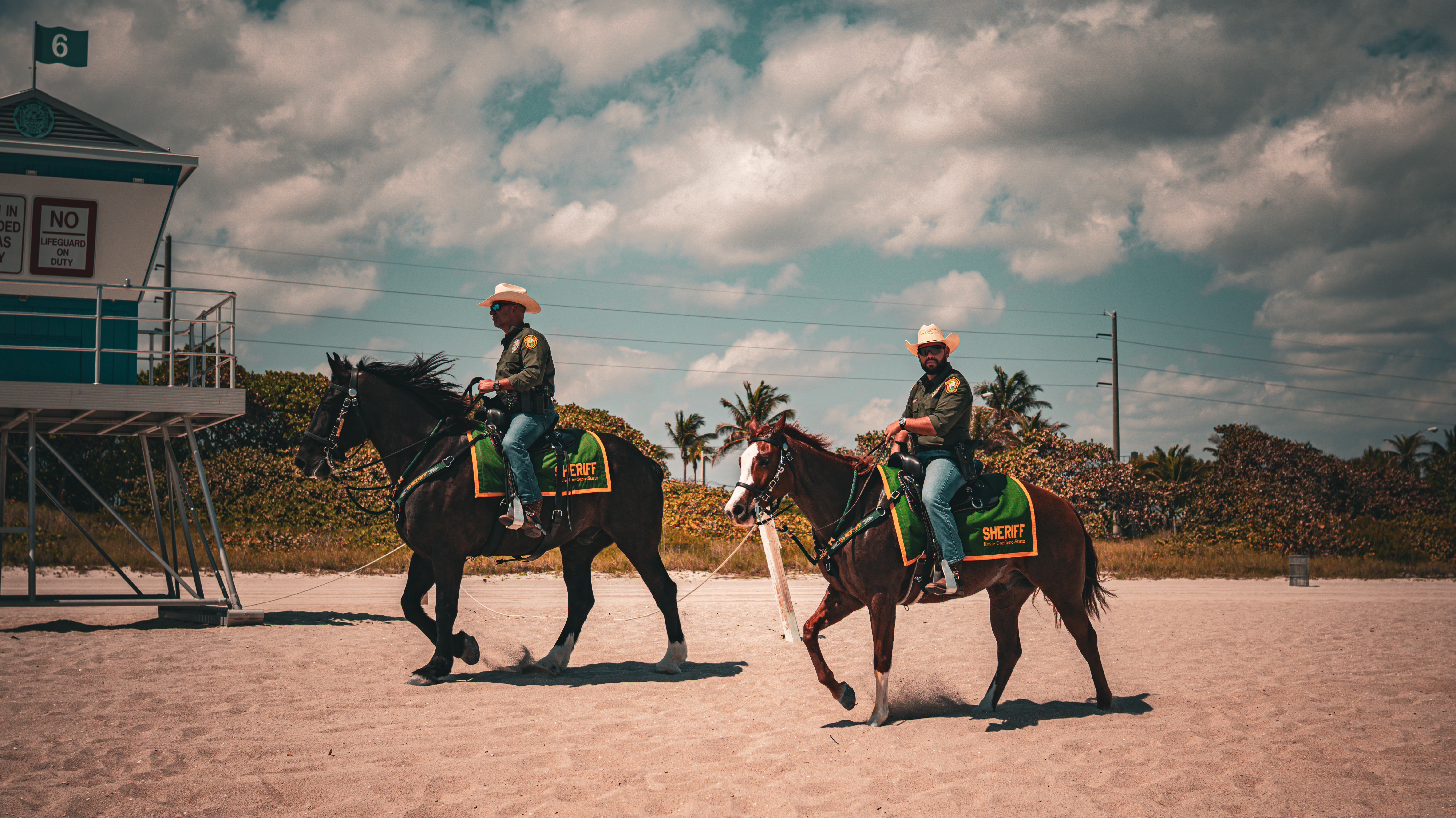 Mounted sheriffs riding through a street