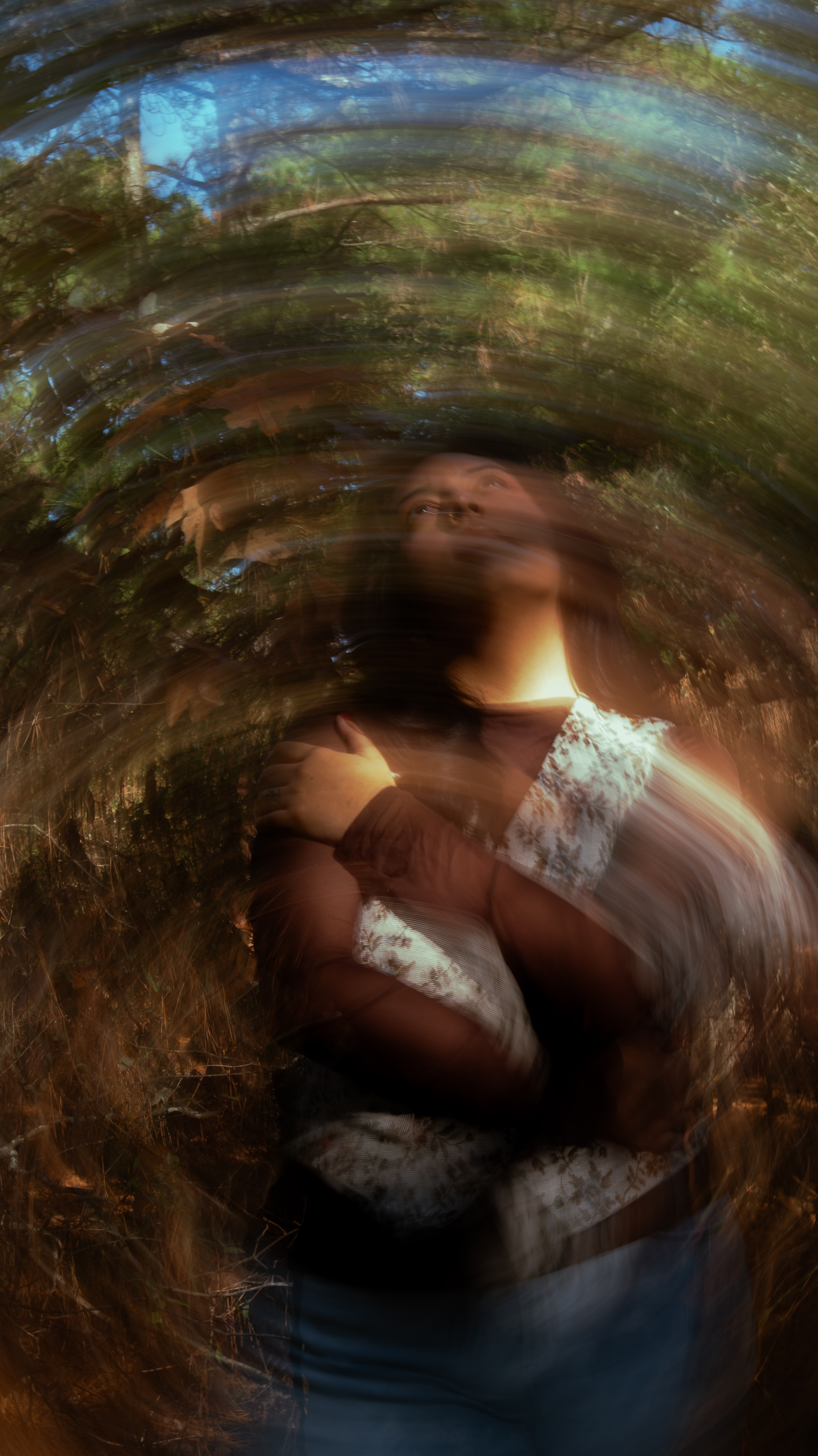 Woman in the woods with arms crossed