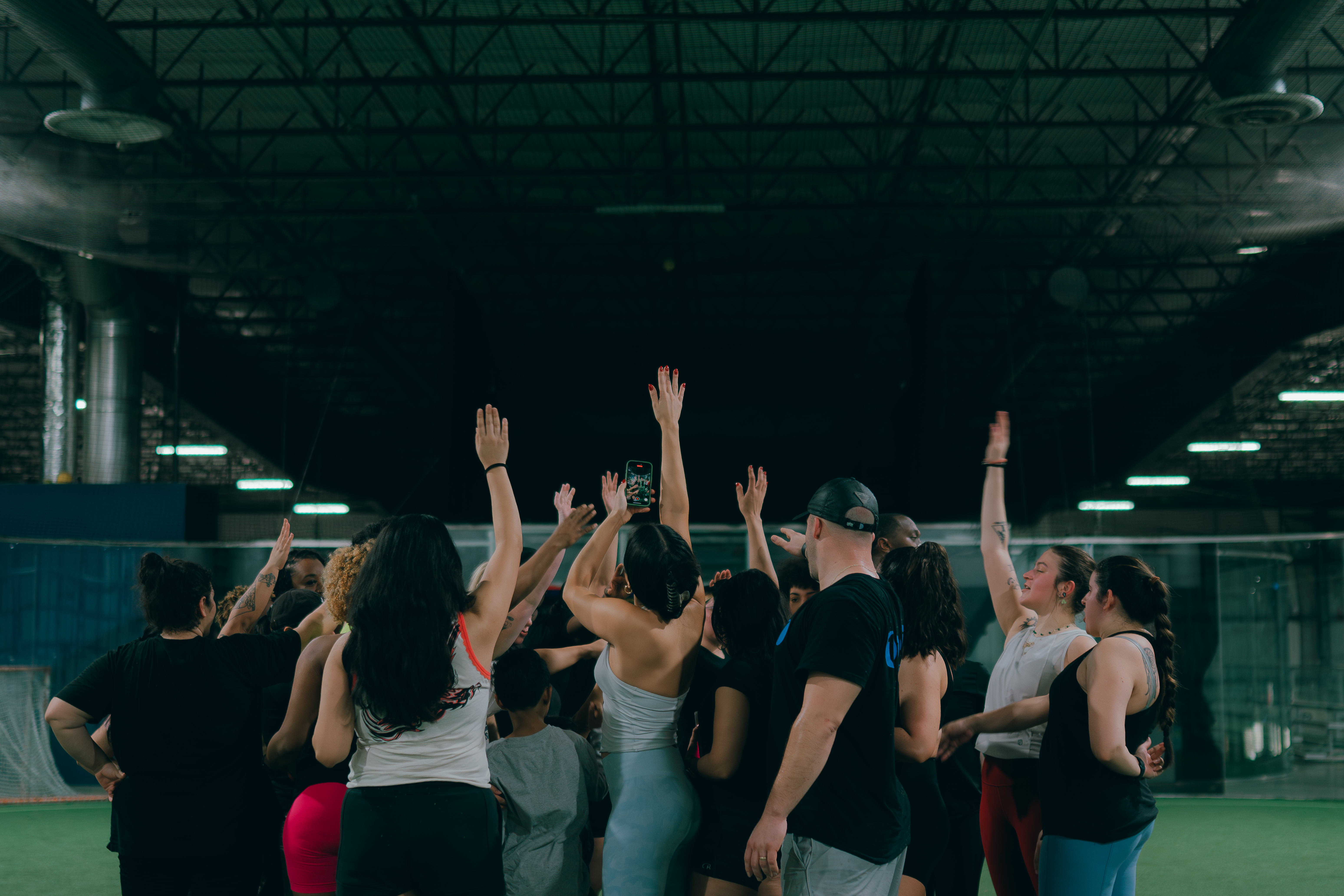 People in a group putting hands in the air
