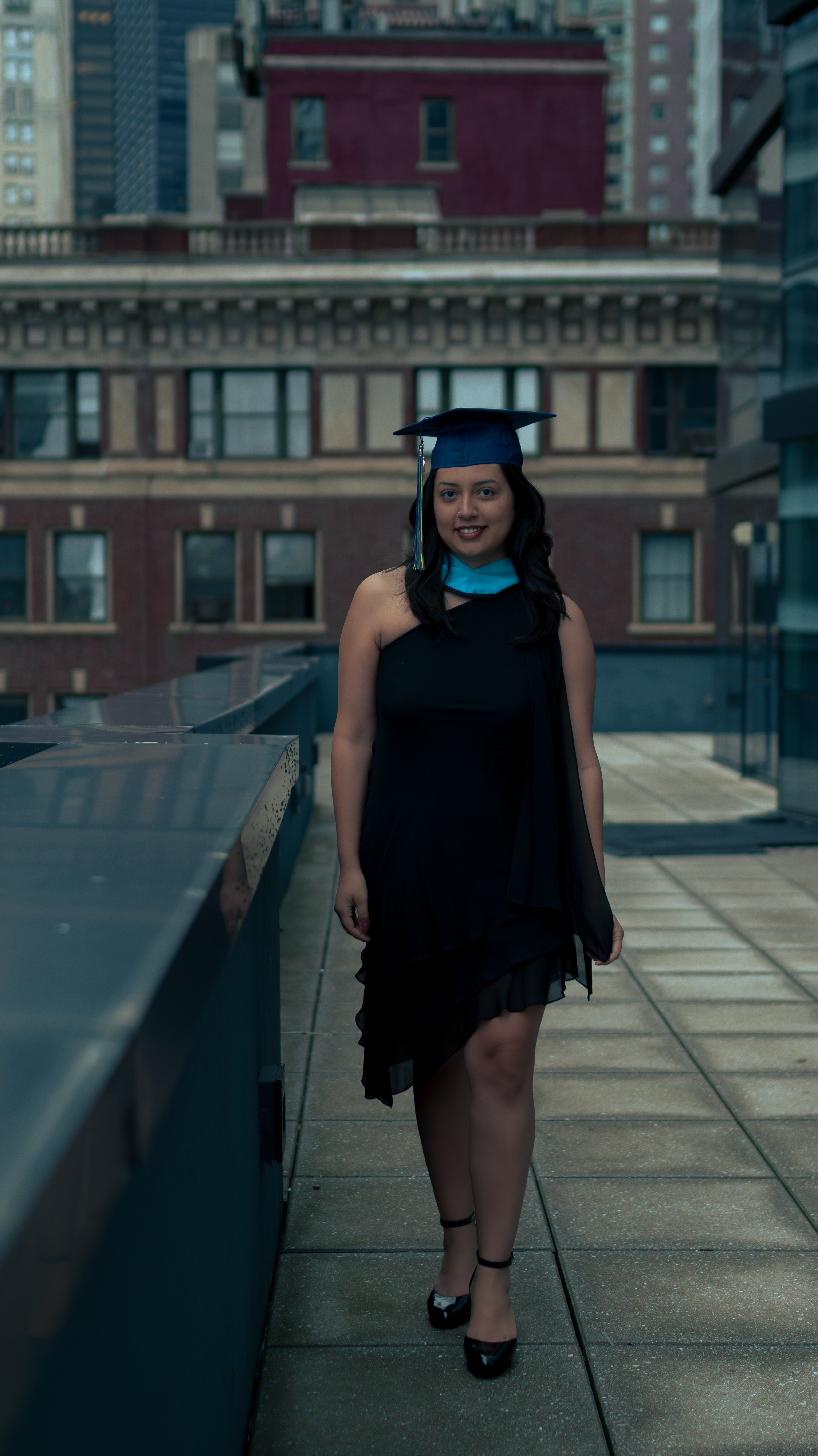 Woman in cap and gown in the city